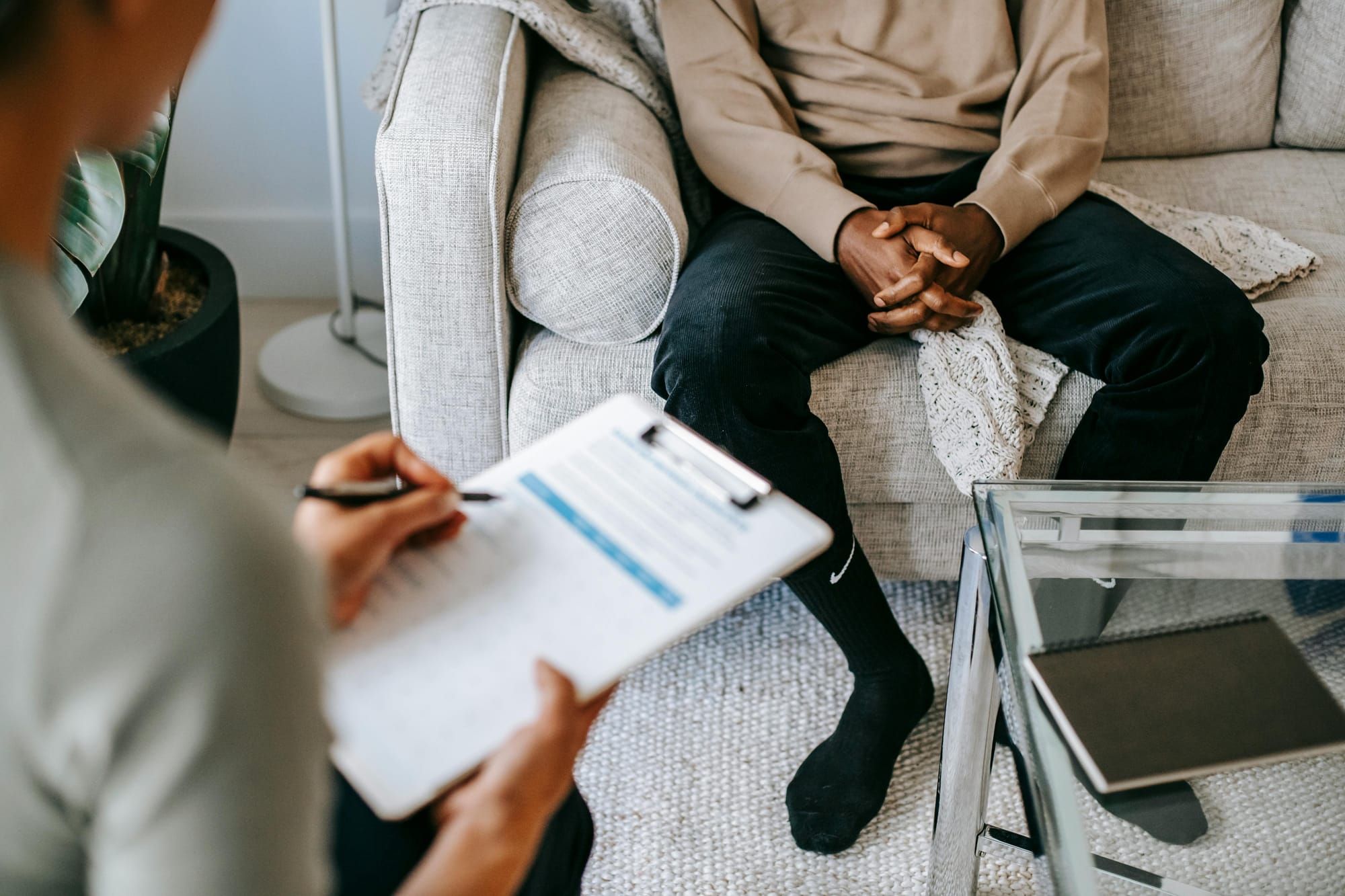 Therapist talking with a patient, face are not visible